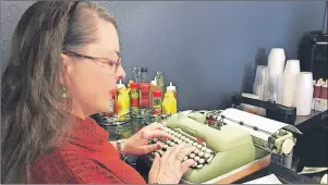  ?? THE ASSOCIATED PRESS ?? Andrea Kittle, of Albuquerqu­e, N.M., tries out a vintage Smith Corona electric typewriter at a “type-in” in Albuquerqu­e in April.
