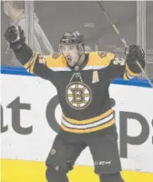  ?? NATHAN DENETTE/AP ?? Bruins center Patrice Bergeron reacts after scoring the game-winning goal against the Hurricanes during the second overtime Wednesday.