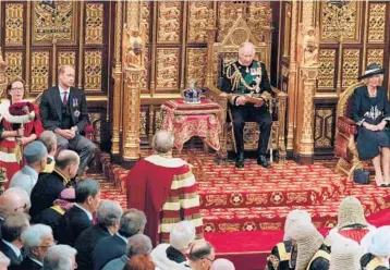  ?? ALASTAIR GRANT/GETTY-AFP ?? Sitting in for the queen: Britain’s Prince Charles, center, is flanked by Camilla, Duchess of Cornwall, and Prince William in the House of Lords during opening ceremonies for Parliament on Tuesday in London. Queen Elizabeth II, 96, missed the ceremonial opening for the first time while she prepares to celebrate 70 years on the throne.