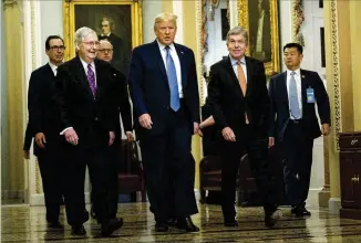  ?? EVAN VUCCI / AP ?? President Donald Trump walks with Senate Majority Leader Mitch McConnell, R Ky. (left), and Sen. Roy Blunt, R-Mo., on Capitol Hill on Tuesday. At back left is Treasury Secretary Steven Mnuchin. Trump has laid out a broad menu of things he wants to do to try to arrest the stock market’s dramatic correction.