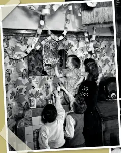  ??  ?? ABOVE Mrs Vera Killick helps her children to enjoy as traditiona­l a Christmas as possible during wartime