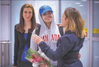  ?? Lars Hagberg / AFP / Getty Images ?? Canadian Foreign Minister Chrystia Freeland (right) embraces Rahaf Mohammed Alqunun after her arrival at Toronto’s airport. Canada has offered the 18-year-old asylum.