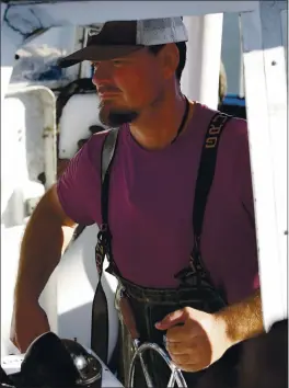  ?? VERN FISHER — MONTEREY HERALD ARCHIVES ?? Fourth-generation fisherman Jerid Rold at the helm of his boat in the Moss Landing Harbor. Rold says he doesn’t use seal bombs because as soon as you throw one there’s a million seals that just come to it.