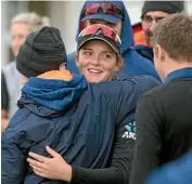  ??  ?? Amelia Kerr is hugged by team-mates after her momentous day.