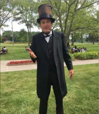  ?? KHADIJA SMITH — MORNING JOURNAL ?? John Cooper portrays President Abraham Lincoln and reads the Emancipati­on Proclamati­on during the fifth annual Juneteenth Bluesfest at Lakeview Park, 1800 W. Erie Ave., in Lorain June 18. President Lincoln issued the Emancipati­on Proclamati­on on...