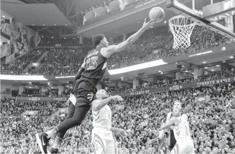  ?? ASSOCIATED PRESS ?? Toronto Raptors forward Malcolm Miller goes for a layup against Houston Rockets during the first half of an NBA basketball game in Toronto.