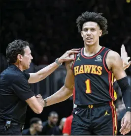  ?? AJC FILE ?? Head coach Quin Snyder is shown greeting Hawks forward Jalen Johnson during the Eastern Conference playoffs in April. Johnson, viewed as the team’s presumptiv­e heir at power forward, could be elevated to starting five this season.