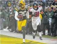  ?? AP PHOTO/MIKE ROEMER ?? The Green Bay Packers’ Bashaud Breeland returns an intercepti­on for a touchdown against the Atlanta Falcons on Sunday in Green Bay, Wis.