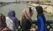  ?? JEROME DELAY — THE ASSOCIATED PRESS ?? Women stand on the “martyrs' bridge” spanning the Tigris River in Baghdad, Iraq, on Feb. 24.