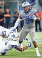  ?? MARK WEBER, THE COMMERCIAL APPEAL ?? University of Memphis running back Darrell Henderson (right) runs over the Georgia State University defender Chris Bacon (left) during action in Memphis, Tenn., Friday, September 14, 2018.