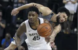  ?? ROD AYDELOTTE ?? Baylor guard Davion Mitchell, left, breaks away from West Virginia guard Jermaine Haley for a fast break in the second half of an NCAA college basketball game, Saturday, Feb. 15, 2020, in Waco, Texas.