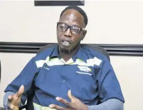  ?? ?? National Solid Waste Management Authority sanitation worker Levar May says he enjoys working with his colleagues to get the job done.