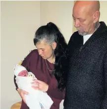  ??  ?? >
Fiona McGrath and her partner David Bravington with Noah and (below) floral tributes to her son