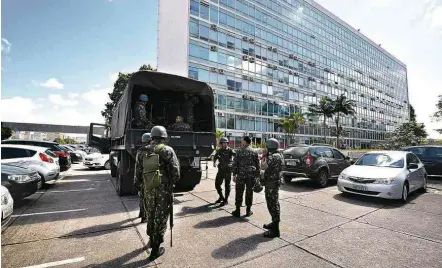  ?? Mateus Bonomi/Agif/Folhapress ?? Militares deixam a Esplanada dos Ministério­s, em Brasília, após revogação de decreto pelo presidente Michel Temer