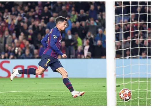  ??  ?? Sharpshoot­er: Barcelona forward Philippe Coutinho scoring the second goal against Lyon during the Champions League last 16, second-leg match at the Nou Camp on Wednesday. — AP