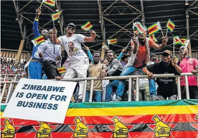  ?? Pictures: AFP ?? MAKING MERRY: People cheer and dance during Zimbabwe Independen­ce Day celebratio­ns at the National Sports Stadium in Harare on Tuesday