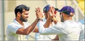  ??  ?? Vidarbha players celebrate the fall of Saurashtra’s wicket