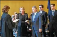  ??  ?? Chester County Controller Margaret Reif is sworn in by President Judge Jacqueline C. Cody at ceremonies held at West Chester University Sykes ballroom Wednesday. Holding the Bible is her husband Joe, with her children Matt and Steve.