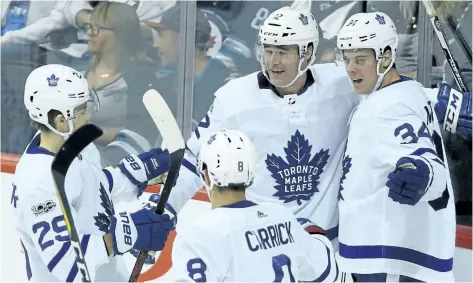  ?? KEVIN KING/POSTMEDIA NETWORK ?? Toronto Maple Leafs’ forward Patrick Marleau (centre) celebrates his goal against the Winnipeg Jets, in Winnipeg, with centre Auston Matthews (right), forward William Nylander (left) and defenceman Connor Carrick, on Wednesday night.