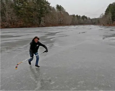  ?? MATT STONE / HERALD STAFF ?? ‘NOTHING BEATS POND SKATING’: Ken Southwood, a volunteer at Turner Pond Lodge in Walpole, checks out the ice conditions Friday as cold air moves into the area.