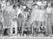  ?? DAVID GOLDMAN/ASSOCIATED PRESS ?? New York Knicks swingman Iman Shumpert (center) celebrates with teammates during Wednesday’s victory in Atlanta.