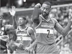  ?? PATRICK SMITH/GETTY IMAGES ?? John Wall (2) shot 12-for-24 from the field to go with nine assists and five boards as the Wizards rebounded after losing by 25 points a night earlier.