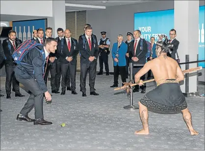  ?? Picture: AFP ?? SHOWING RESPECT: British and Irish Lions captain Sam Warburton, front, accepts the challenge and picks up the ’rautapu’ (ceremonial leaf) as he and the rest of the squad receive a traditiona­l Maori welcome upon their arrival at Auckland Airport...