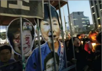  ?? AHN YOUNG-JOON - THE ASSOCIATED PRESS ?? Protesters with portraits of impeached President Park Geun-hye march towards the presidenti­al house during a candle light vigil calling for her arrest in Seoul, South Korea, Saturday. South Korean police on Saturday braced for more violence between...