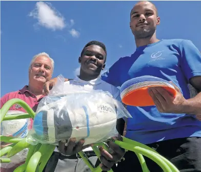  ?? Picture: FREDLIN ADRIAAN ?? WELCOME KIT: Ithembelih­le High School coach Theo Pieterse, left, rugby captain Simamkele Gqala and Wayde Douglas, of the Eastern Cape Academy of Sport, at the handover of training equipment to the school