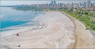  ?? — AFP file photo ?? An aerial view of Turkey’s Marmara Sea at a harbour on the shoreline of Istanbul shows mucilage, a jelly-like layer of slime that develops on the surface of the water due to the excessive proliferat­ion of phytoplank­ton, gravely threatenin­g the marine biome.