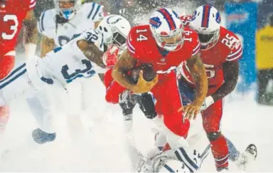  ?? Brett Carlsen, Getty Images ?? The Bills’ Joe Webb gains yardage through the snow and the Colts on Sunday.