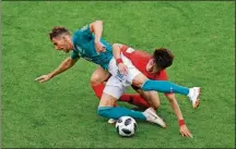  ?? SERGEI GRITS/THE ASSOCIATED PRESS ?? Germany’s Leon Goretzka fights for the ball with South Korea’s Lee Jaesung (right) during the Group F match Wednesday in the Kazan Arena in Kazan, Russia.