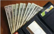  ?? ELISE AMENDOLA/THE ASSOCIATED PRESS, FILE ?? In this June 15, 2018, photo, cash is fanned out from a wallet in North Andover, Mass.