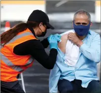  ?? FILE PHOTO BY JANE TYSKA — BAY AREA NEWS GROUP ?? California Department of Public Health Director and State Public Health Officer Dr. Tomás Aragón receives a vaccine shot during a press conference at the Oakland Coliseum vaccinatio­n site in Oakland earlier this year.