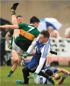  ?? OLIVER McVEIGH/SPORTSFILE ?? Kerry’s Brian Ó Beaglaíoch is upended as Monaghan’s Rory Beggan makes a save during yesterday’s Division 1 clash