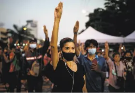  ?? Jack Taylor / AFP / Getty Images ?? Prodemocra­cy demonstrat­ors raise their signature threefinge­r salute in the capital of Bangkok as they call on Prime Minister Prayuth Chanocha to resign.