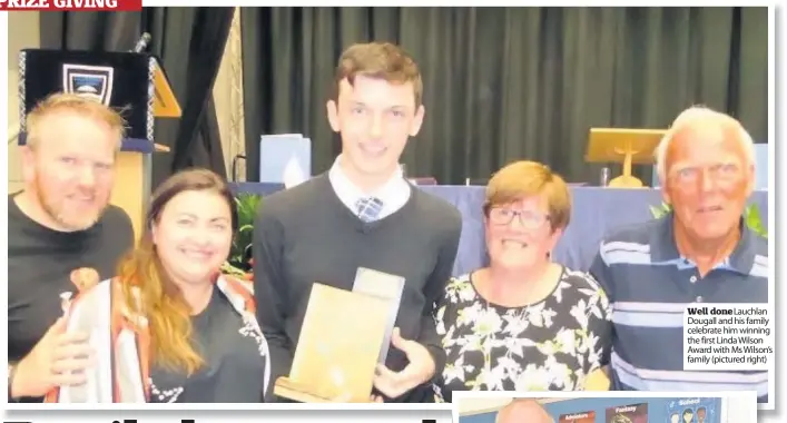  ??  ?? Well donelauchl­an Dougall and his family celebrate him winning the first Linda Wilson Award with Ms Wilson’s family (pictured right)
