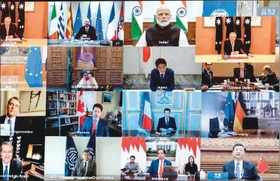  ?? (AFP) ?? G20 leaders are seen on a screen attending a videoconfe­rence to discuss the COVID-19 coronaviru­s, in Canberra on Thursday.