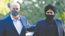  ?? CP/ FILES ?? NDP Leader John Horgan with the party's candidate, Aman Singh, in Richmond-Queensboro­ugh earlier this month.