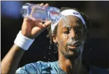  ?? ANDY BROWNBILL — THE ASSOCIATED PRESS ?? Gael Monfils showers himself with water during his second-round match with Novak Djokovic at the Australian Open in Melbourne, Australia, Thursday.