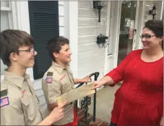  ?? Photo contribute­d by Mary Hardin Thornton ?? Wyatt Thornton (from left) and Henry Thornton hand informatio­n about the Scouting for Food drive to Stephanie Bennett.