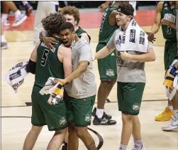  ?? DOUG MCSCHOOLER — THE ASSOCIATED PRESS ?? Ohio players celebrate on the court after defeating Virginia in a first-round game in the NCAA Tournament on Saturday at Assembly Hall in Bloomingto­n, Ind.