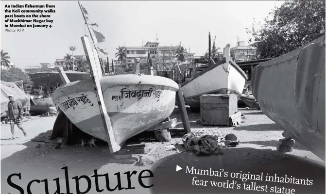  ?? Photo: AFP ?? An Indian fisherman from the Koli community walks past boats on the shore of Machhimar Nagar bay in Mumbai on January 4.