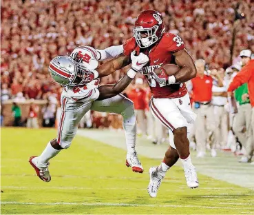  ?? [PHOTO BY NATE BILLINGS, THE OKLAHOMAN] ?? OU’s Samaje Perine tries to break free from Ohio State’s Malik Hooker in the Buckeyes’ 45-24 victory last September. Now the teams meet again, this time in Columbus, Ohio.