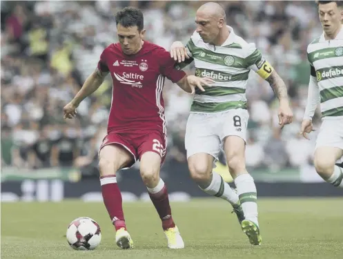  ??  ?? 0 Ryan Jack, who produced an assured display for Aberdeen in Saturday’s Scottish Cup final, shields the ball from Celtic’s Scott Brown.