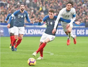  ??  ?? France defender Benjamin Pavard (C) vies with Uruguay forward Edinson Cavani during a November 20 friendly at the Stade de France. - AFP photo