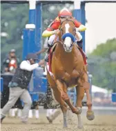  ?? JULIO CORTEZ/ASSOCIATED PRESS ?? BOTTOM RIGHT: Justify, with Smith, breaks out of the starting gate and led the entire race.