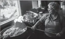  ?? DENNIS M. RIVERA PICHARDO / THE NEW YORK TIMES ?? A volunteer cooks rice on Thursday to be distribute­d in Cidra. Although 86 percent of the island’s supermarke­ts are open, the government could not ensure that they were fully stocked with food and water.