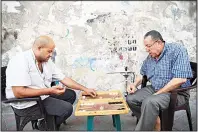  ??  ?? Palestinia­n men play backgammon in Gaza City on May 26. (AFP)