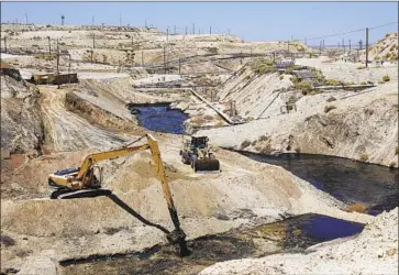  ?? Irfan Khan Los Angeles Times ?? CLEANUP continues at the spill site at an abandoned oil well in McKittrick. Gov. Gavin Newsom, though vowing to rein in fossil fuel production, emphasized the oil industry’s economic importance to California.